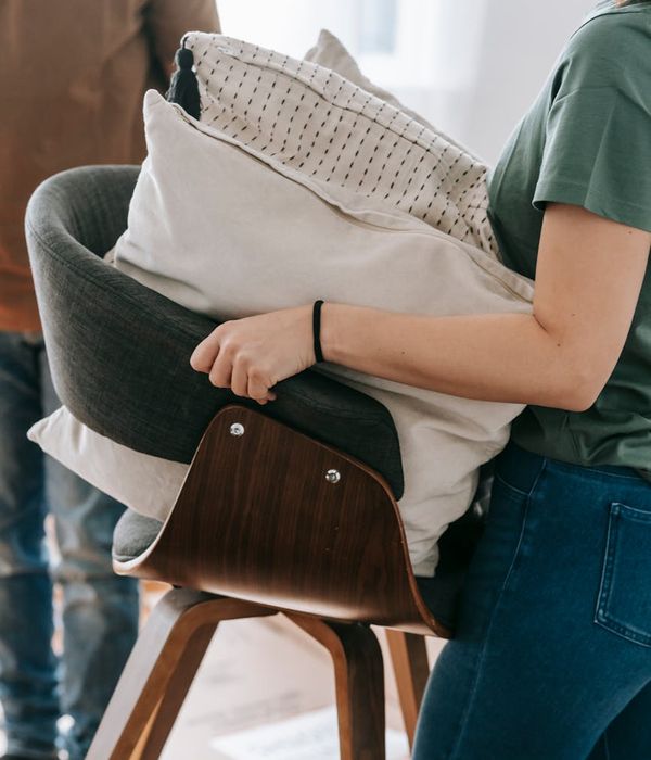 Woman feeling energized and balanced in a modern living room.